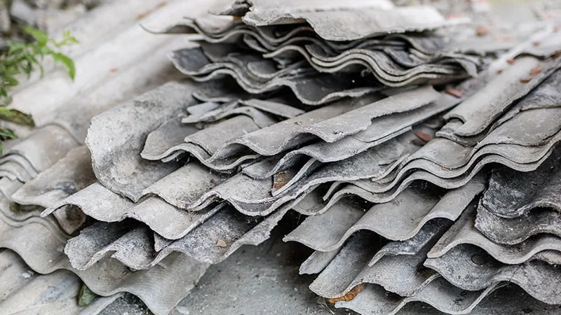 Stack of older corrugated sheets that may contain asbestos